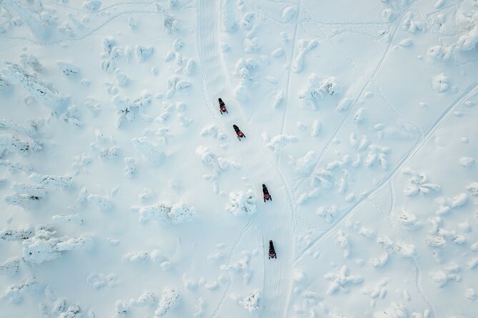 Lappish Lunch Break -Snowmobiling, ice fishing and tasty food - Snowmobiling Through Frozen Rivers: The Ride Is the Point