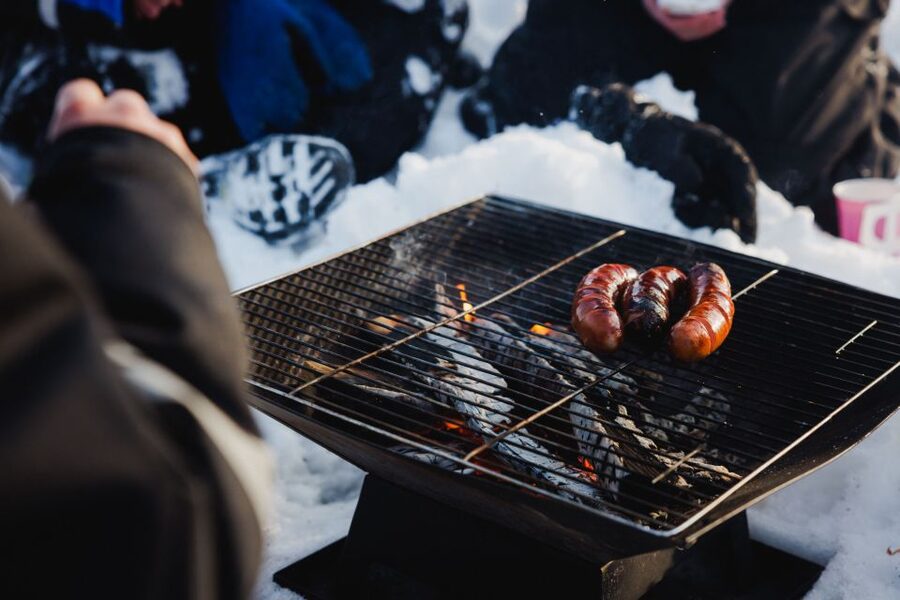 Rovaniemi: Arctic Circle Ice Fishing Experience - Campfire comfort: warm juice and sausages on frozen ground